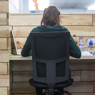 Student sat at a desk in Frenchay Library.