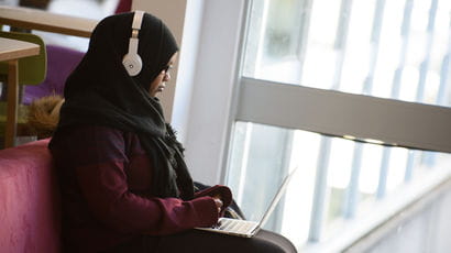 Student using a laptop in the library