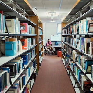 Books on shelves in Frenchay Campus Library.