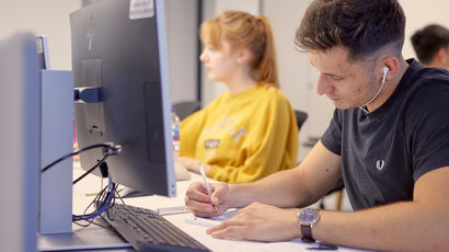 Two students working on computers.