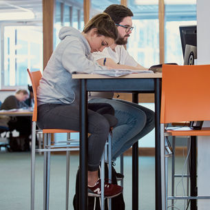 Students at a desk in the library.