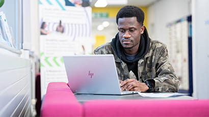 Student working on laptop in Glenside Library