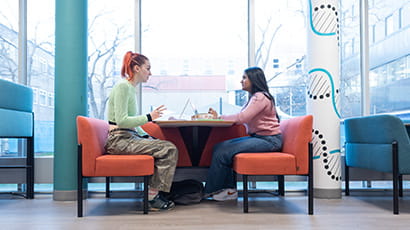 Students sat chatting at a desk