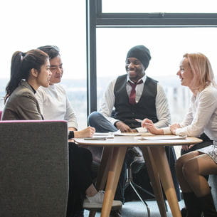 Group of people attending a meeting at a table. Group of people attending a meeting at a table.