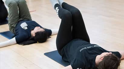 Students joining an exercise class using ballet techniques