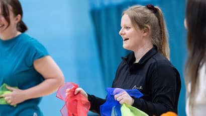 Students dancing with colourful scarves