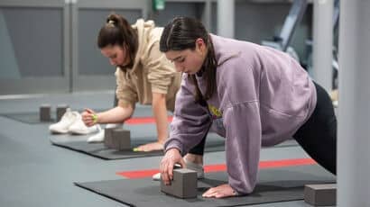 Students practicing yoga in a studio
