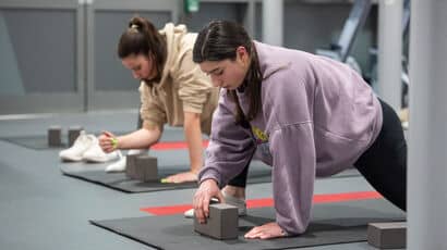 Students practicing yoga in a studio