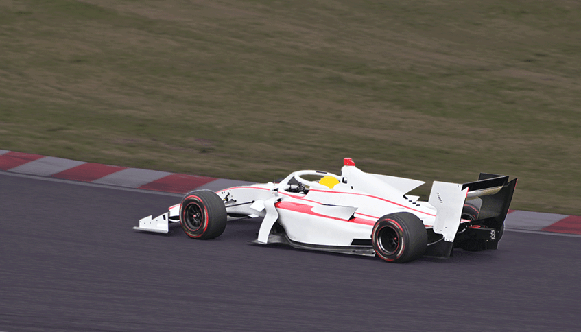 A F1-style white car on a racing track.