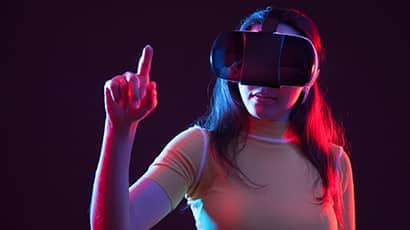 Young girl with VR goggles on head.