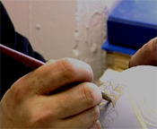 Dale Bowen decorating a vase using the pate-sur-pate technique