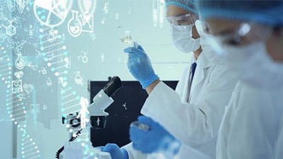 Two people in while lab clothing and face masks working with a flask, a syringe and a microscope.